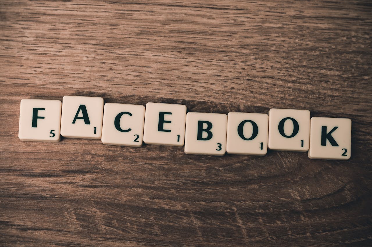 why-choose-us Scrabble tiles spelling 'Facebook' on a wood background, symbolizing social media.